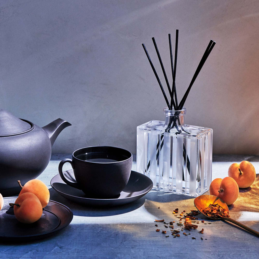 Apricot Tea Reed Diffuser by NEST New York with tea, teapot, apricots, and spices
