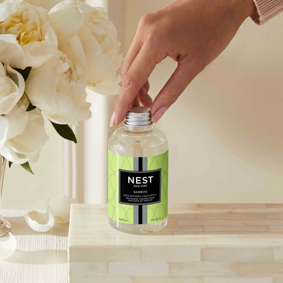 Bamboo Reed Diffuser Liquid Refill by NEST New York with hand model