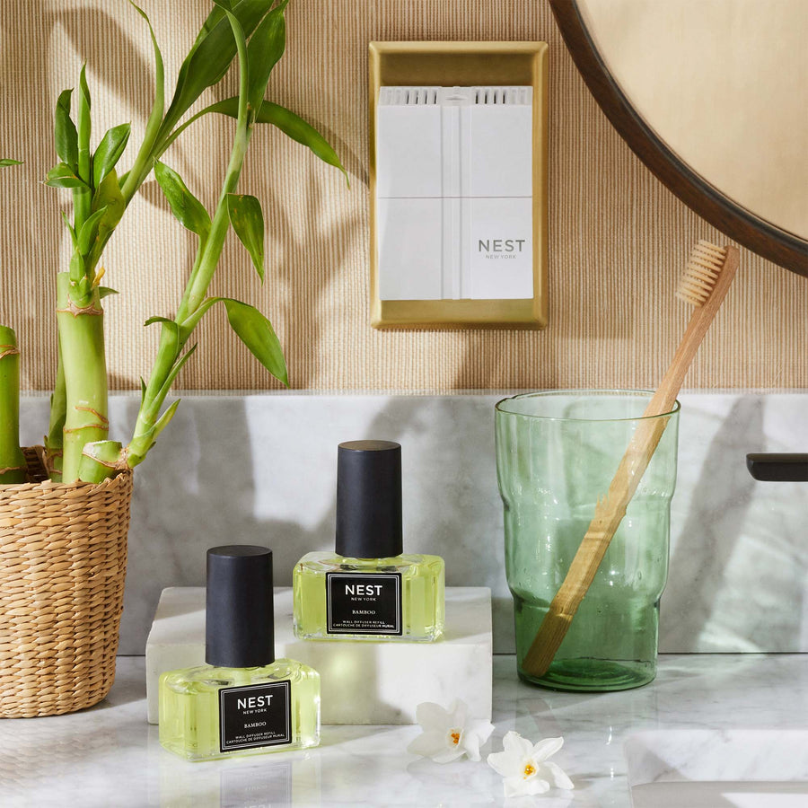 Bamboo Refills for Wall Diffuser by NEST New York with wall diffuser, bamboo, wicker basket, and toothbrush