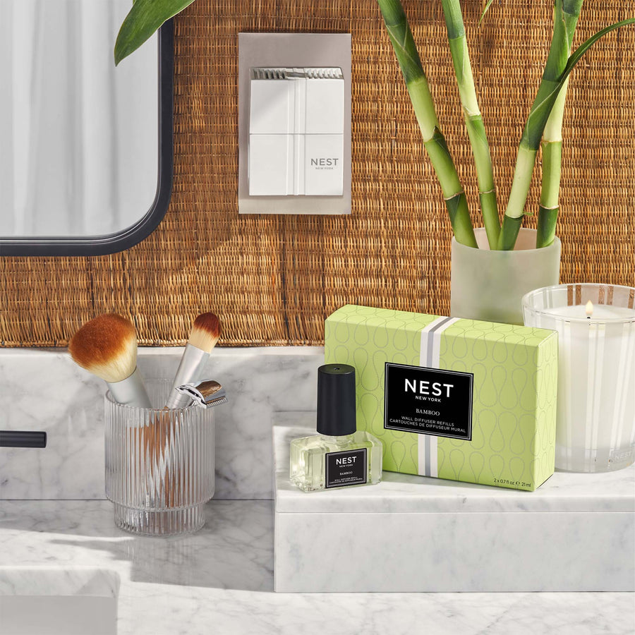 Bamboo Refills for Wall Diffuser and Bamboo Classic Candle by NEST New York with wall diffuser, bamboo, and makeup brushes