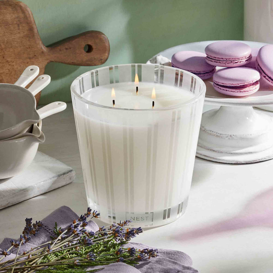 Cedar Leaf & Lavender 3-Wick Candle by NEST New York with macarons, lavender, cedar, and pots
