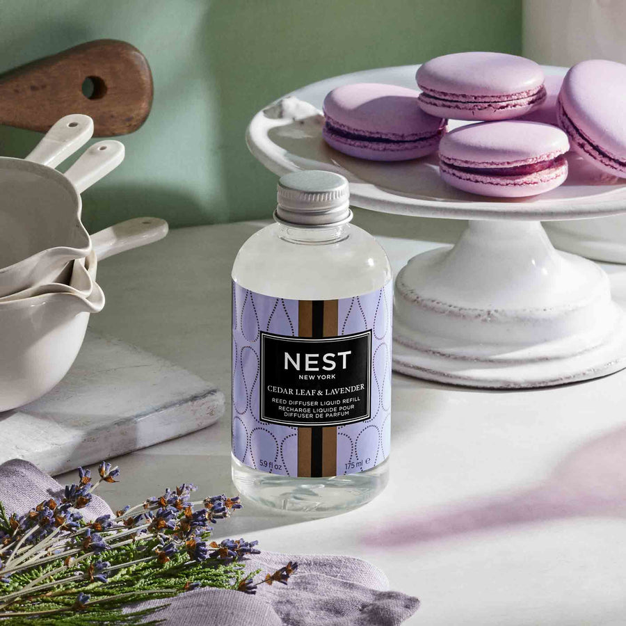 Cedar Leaf & Lavender Reed Diffuser Liquid Refill by NEST New York with macarons, lavender, cedar, and pots