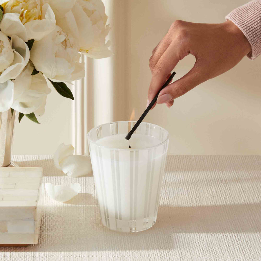 Amalfi Lemon & Mint Classic Candle by NEST New York with hand, match, and flowers