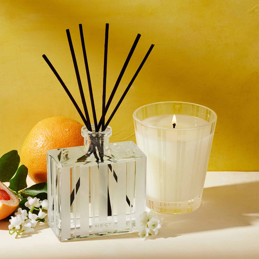Grapefruit Reed Diffuser and Classic Candle by NEST New York with grapefruit and flowers
