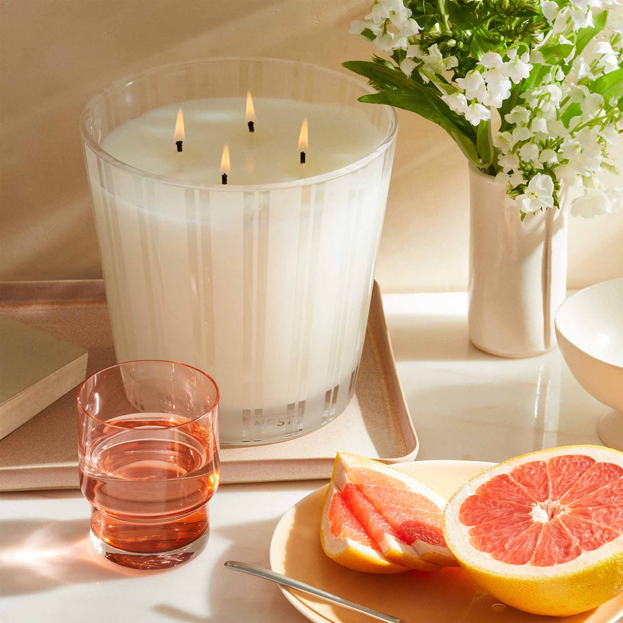 Grapefruit Luxury Candle by NEST New York with grapefruit, water, and flowers