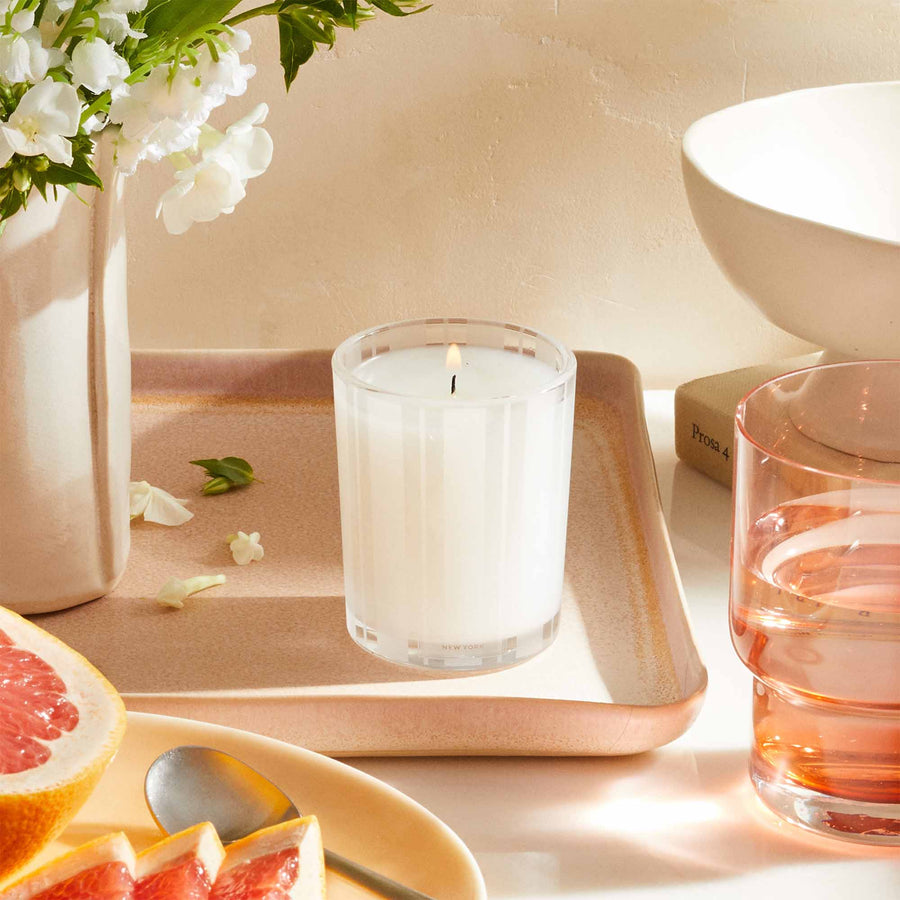Grapefruit Votive Candle by NEST New York with grapefruit, water, and flowers