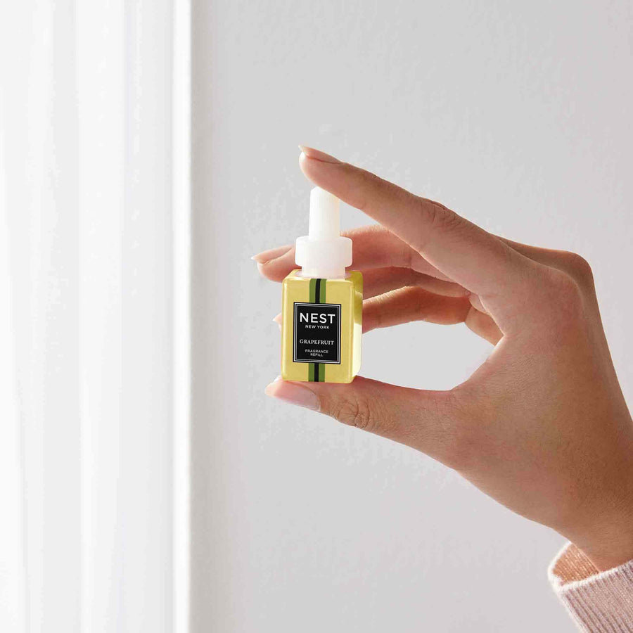 Grapefruit Pura Refill by NEST New York with hand model