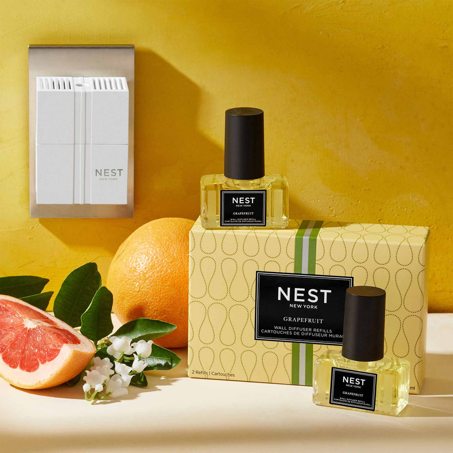 Grapefruit Refills for Wall Diffuser by NEST New York with wall diffuser, grapefruit, and flowers
