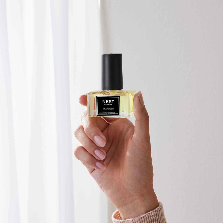 Grapefruit Wall Diffuser Refill by NEST New York with hand model