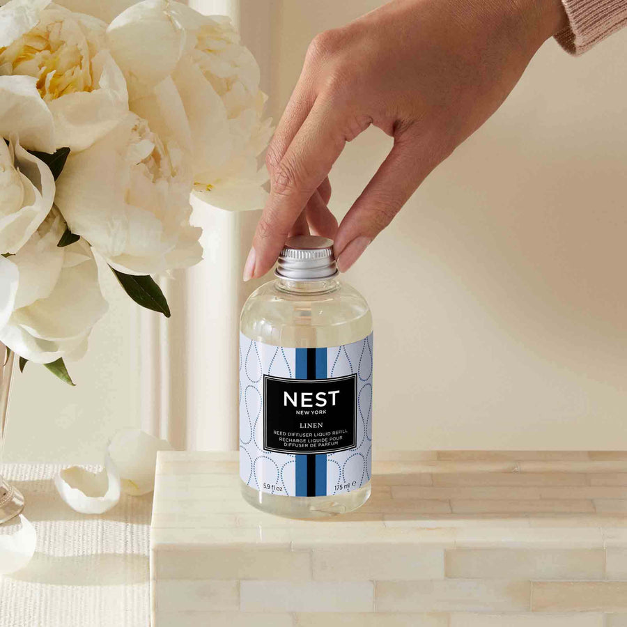 Linen Reed Diffuser Liquid Refill by NEST New York with hand model