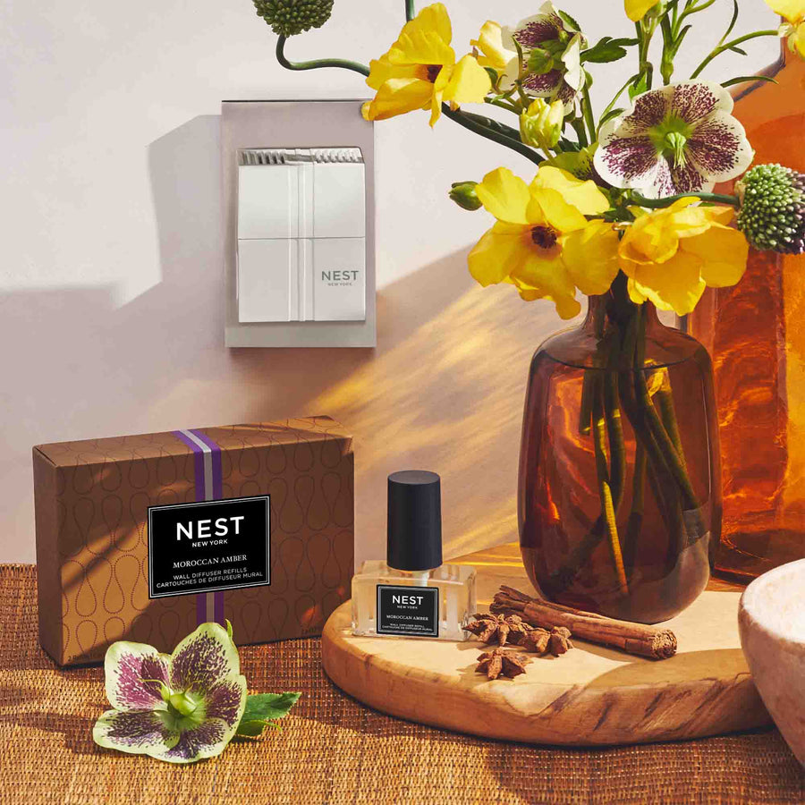 Moroccan Amber Refills for Wall Diffuser by NEST New York with wall diffuser, flowers, vase, and spices