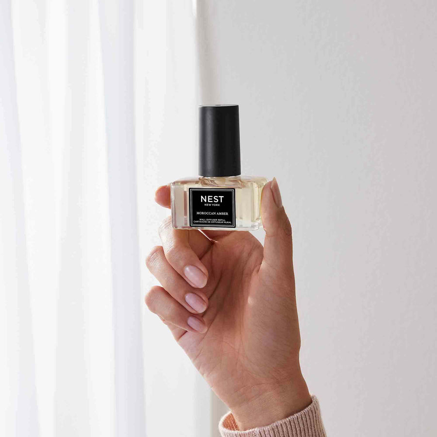 Moroccan Amber Wall Diffuser Refill by NEST New York with hand model