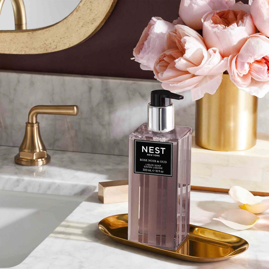 Rose Noir & Oud Liquid Soap by NEST New York with roses in a vase 