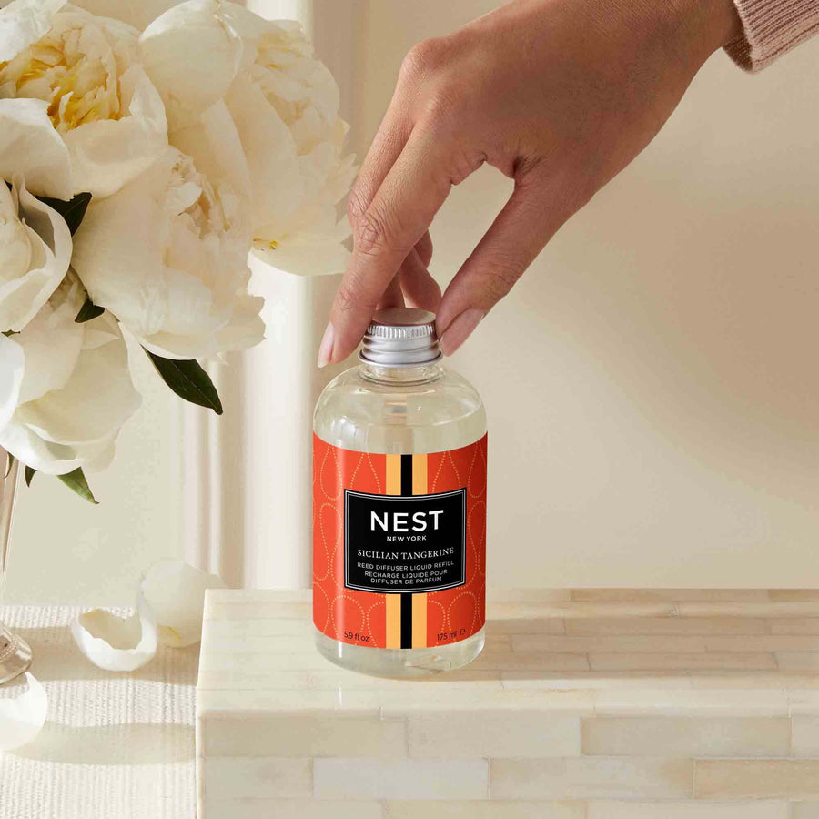 Sicilian Tangerine Reed Diffuser Liquid Refill by NEST New York with hand model