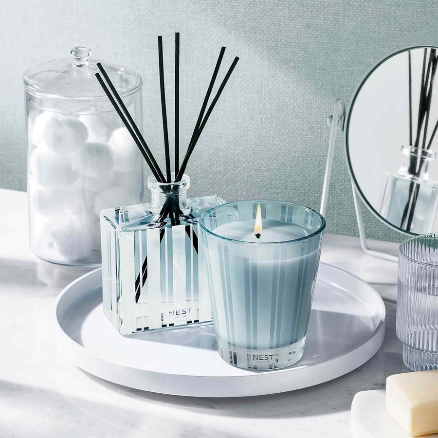 Driftwood & Chamomile Classic Candle and Reed Diffuser by NEST New York with cotton balls and mirror