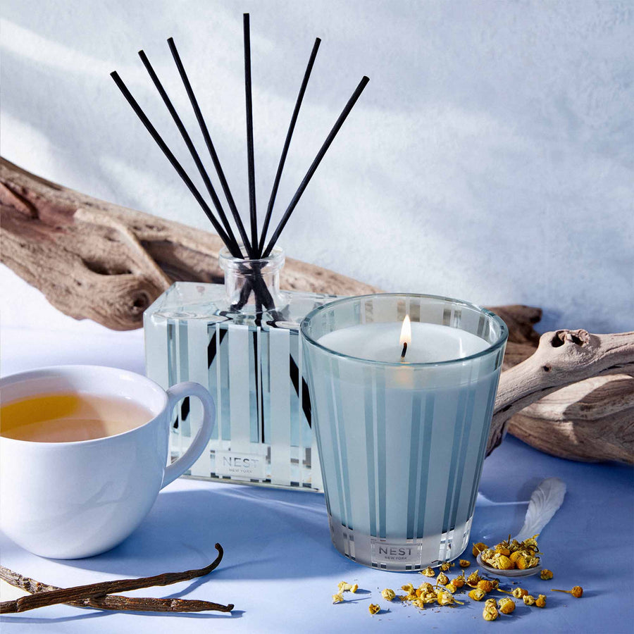 Driftwood & Chamomile Classic Candle & Reed Diffuser by NEST New York with tea and driftwood